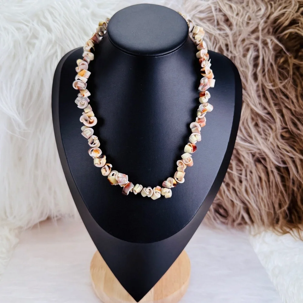 Beautiful vintage necklace composed of curly-cut conch shell beads individually